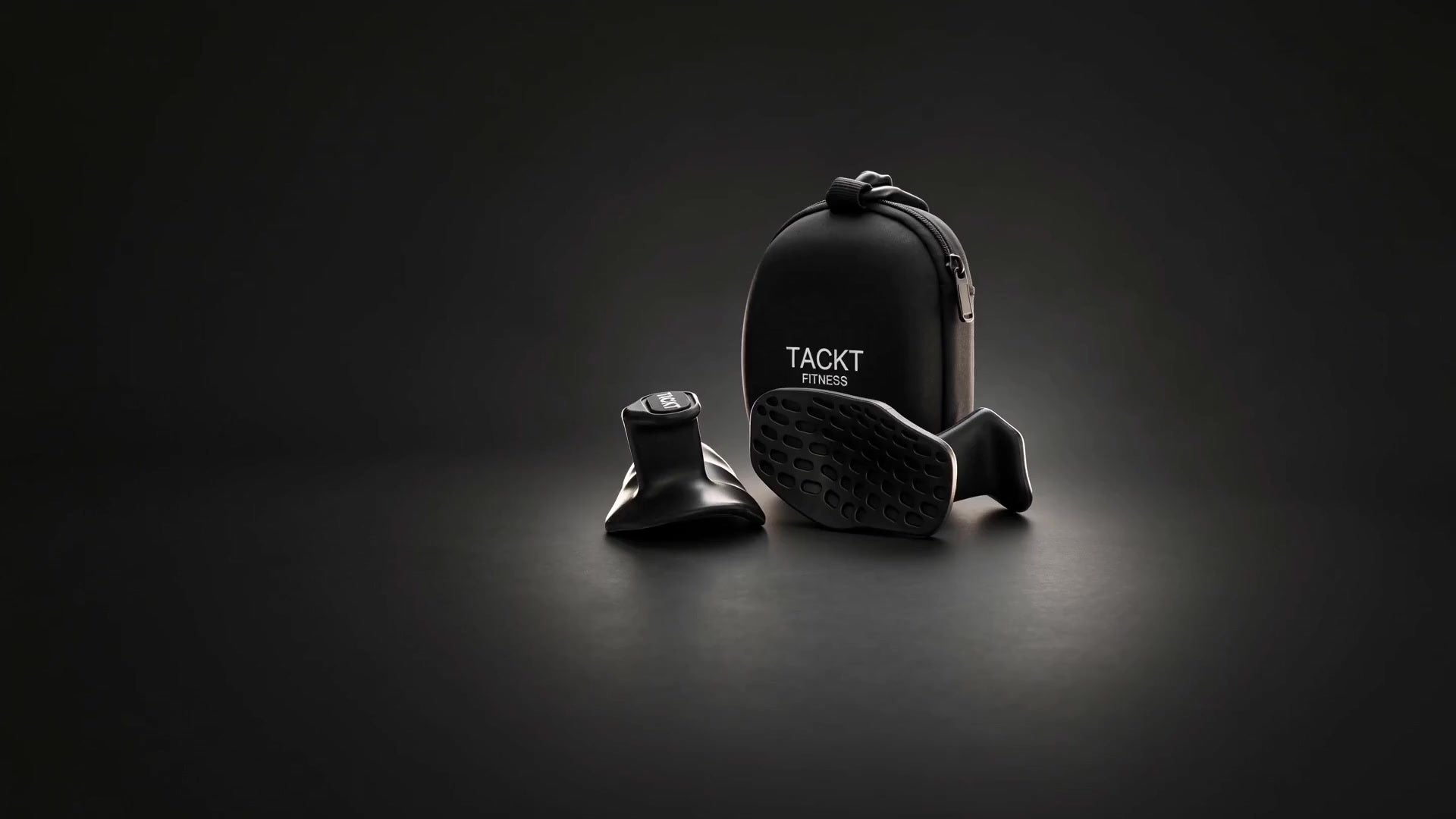 TACKT grip pair and zip case in a continuous studio scene