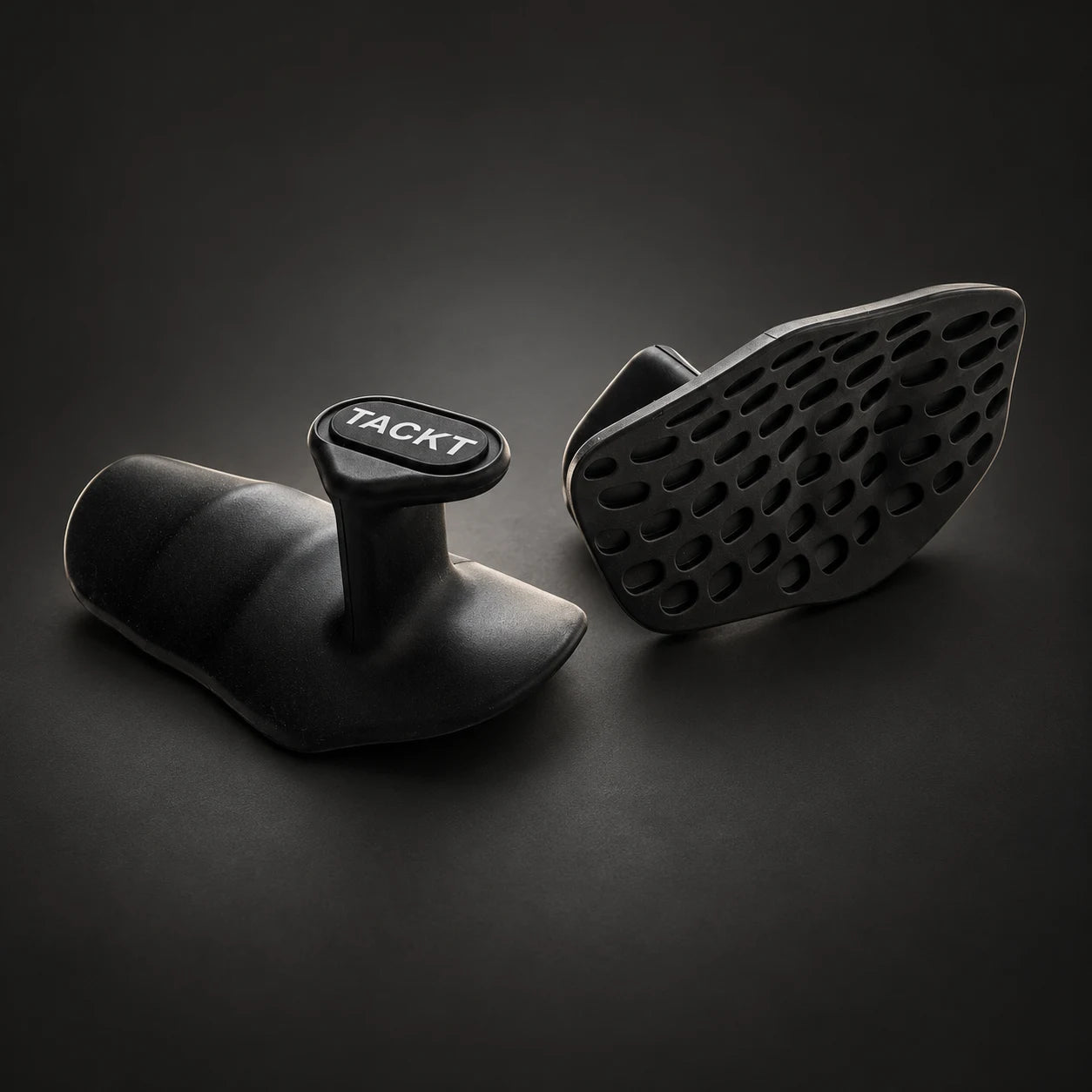 TACKT Fitness Grips showing the textured gripping surface and central finger tab